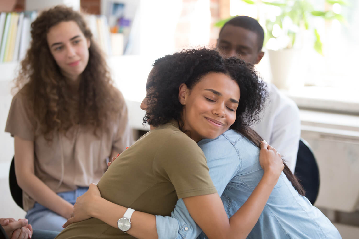 Carer hugging patient